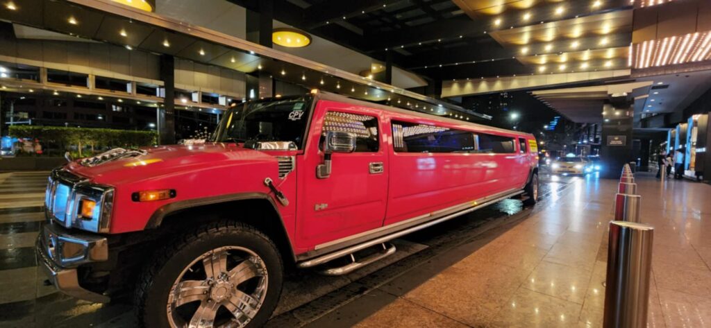 pink limo hummer at night